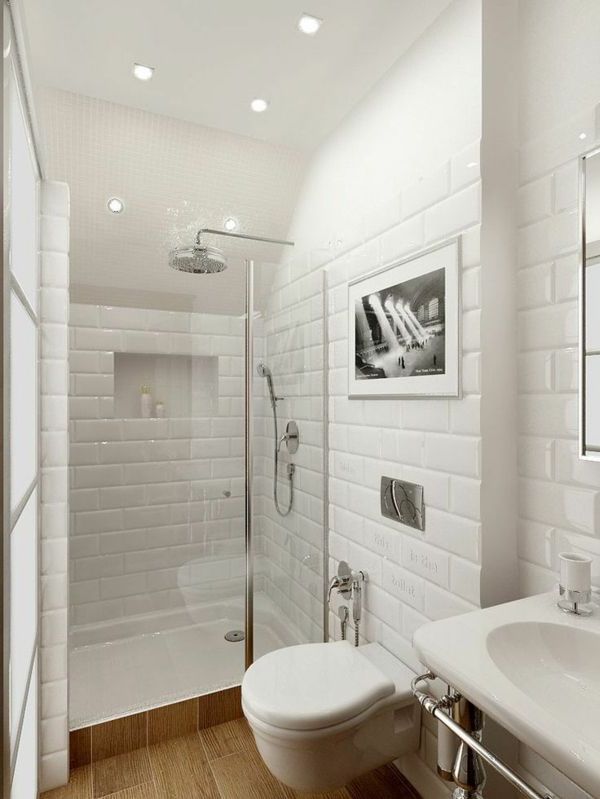 Revestimiento de azulejos rectangulares blancos con mucho brillo, ducha pequeña con mampara, suelos de madera